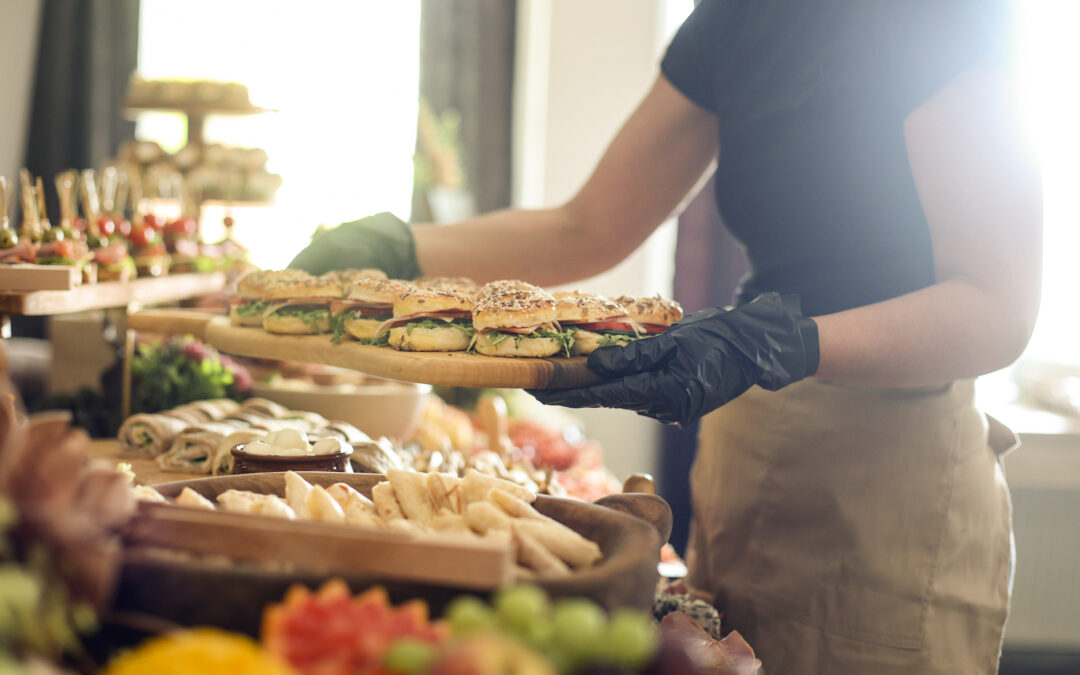 Caterer serving a large buffet table