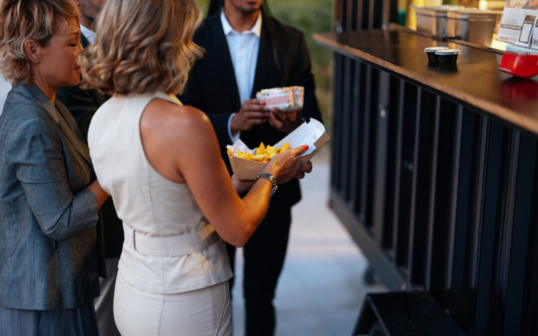 Business people enjoying street food from a food truck